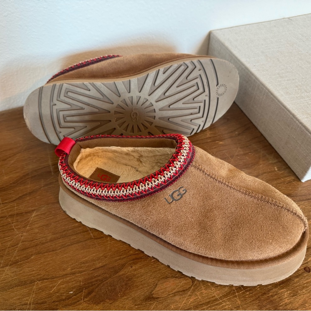 UGG Tazz slip-ons in Chestnut with red trim.